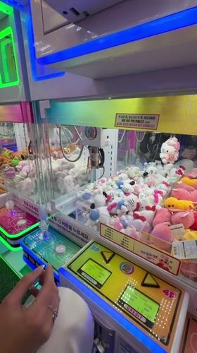 Person plays claw machine at neon-lit Seoul arcade