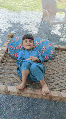 Young boy in blue clothing observed in quiet moments