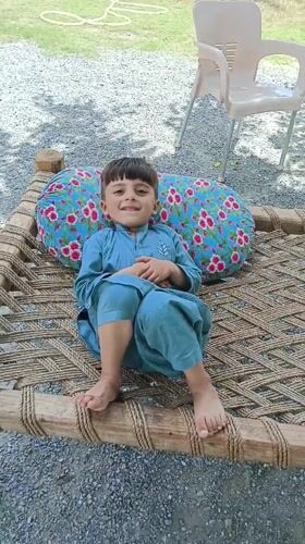 Young boy in blue clothing observed in quiet moments