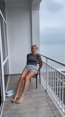 Woman performs morning exercises on balcony in Giachrypsh