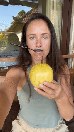 Woman enjoys tropical fruit sampling session in Ubud, Indonesia