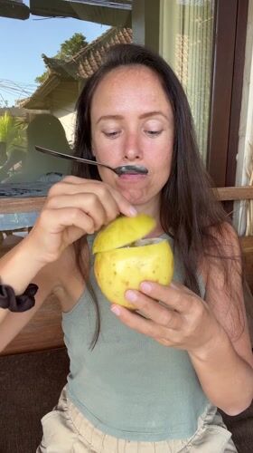 Woman enjoys tropical fruit sampling session in Ubud, Indonesia