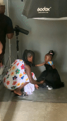 Photography session underway in Nigerian studio with woman, child