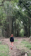 Woman and poodle explore Baturiti bamboo forest by foot and cart