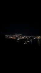 Nighttime coastal city lights captured in Šušanj, Montenegro