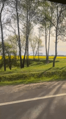 Vehicle travels rural road near Minsk, Belarus early morning