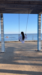 Woman on swing turns to smile in Laishevo
