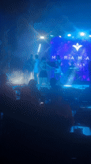 Live performance at a colorfully lit resort venue after dark