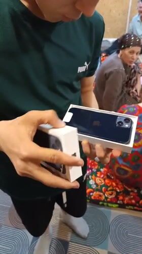Man unboxes new iPhone in Nizhnevartovsk, Russia