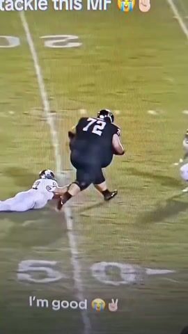 A football player wearing number 72 in a black jersey is running with the ball. Another player in a white jersey is attempting to tackle him and has fallen to the ground. A third player in a white jersey is running past. Text overlays read "I wouldn't even attempt to tackle this MF" and "I'm good".
