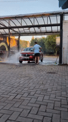 Cars getting washed at an outdoor bay in Mykolaiv