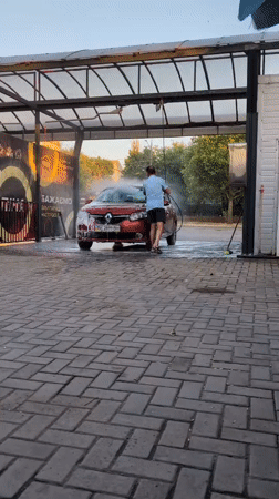 Cars getting washed at an outdoor bay in Mykolaiv
