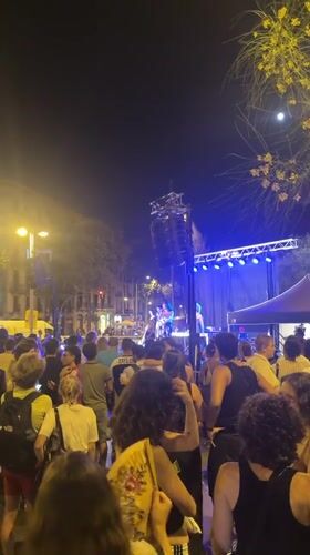 Blue-lit stage, moonlit sky: outdoor concert night in Barcelona