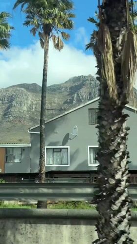 Table Mountain viewed through clouds from Cape Town roadside