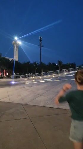 Nighttime Plaza Activities Captured Near Lighthouse in Bai Chay Ward