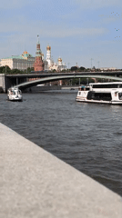 Boats navigate Moscow River under clear skies