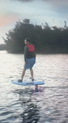 Man rides electric hydrofoil board wearing safety vest