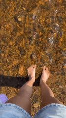 Person enjoys barefoot wading in clear waters near Zelenogorsk