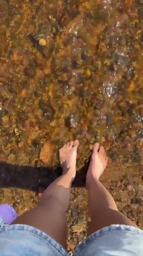 Person enjoys barefoot wading in clear waters near Zelenogorsk