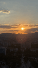 Sunset over Konya's skyline, mountains on the horizon