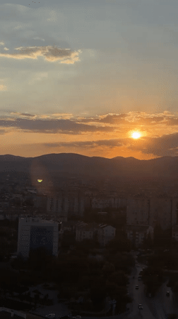 Sunset over Konya's skyline, mountains on the horizon