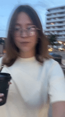 Woman with coffee cup walks through Podgorica streets