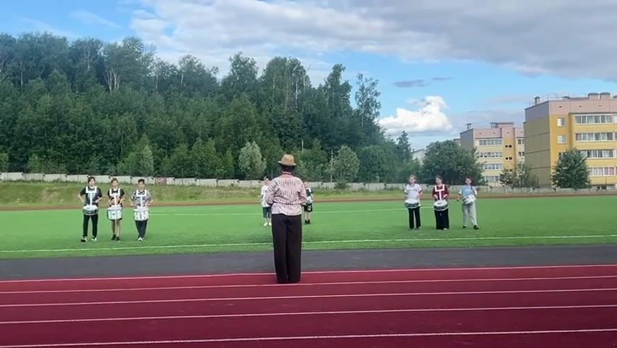 Youth drumline practices at sports field in Noviy, Russia