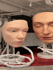 Large face sculptures displayed in Paris art installation