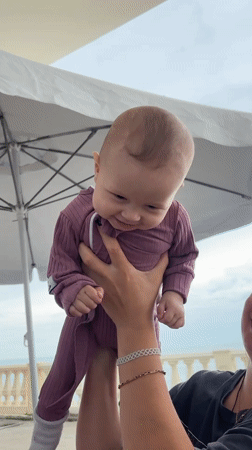 Woman enjoys beach day with baby and dog in Sochi