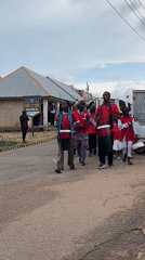 Drumming procession in red shirts moves through Jos streets