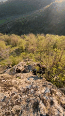 Hikers climb rocky hillside in Goritsa, Bulgaria