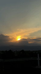 Sunset captured over Mexico City with mountains and urban landscape