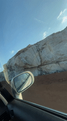 Motorist drives through Nigerian quarry, encounters herded cattle