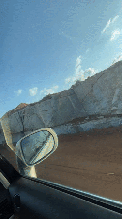 Motorist drives through Nigerian quarry, encounters herded cattle