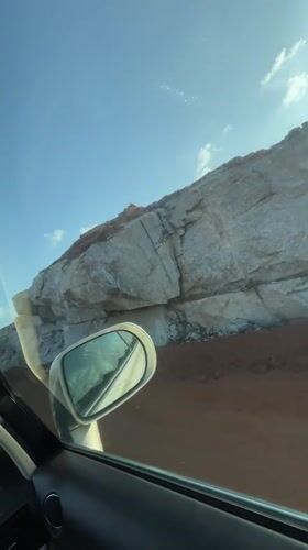Motorist drives through Nigerian quarry, encounters herded cattle