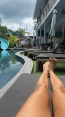 Resort guest relaxes poolside in Baan Mae Nam, Thailand