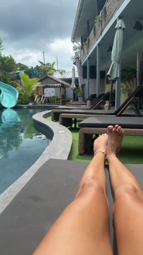 Resort guest relaxes poolside in Baan Mae Nam, Thailand