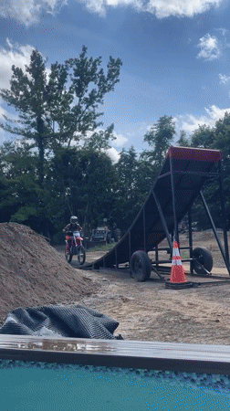 Backyard motocross ramp session with airbag and pool