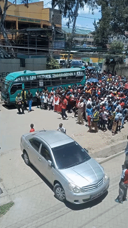 Crowd gathers outside Nairobi church with circus buses present