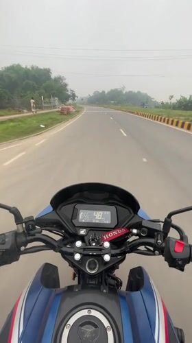 Motorcyclist rides Honda bike through Purbachal, Bangladesh at night