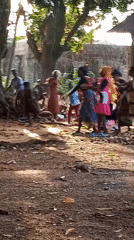 Colorful traditional dance or ceremony in a village courtyard
