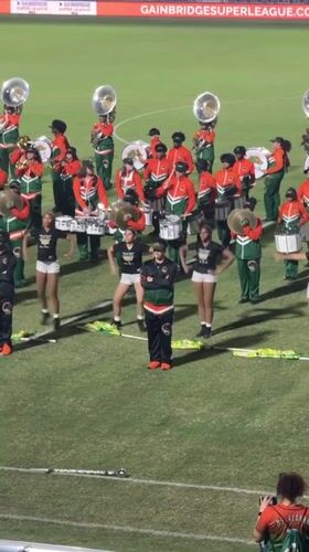 College marching band performs at nighttime stadium event in Davie
