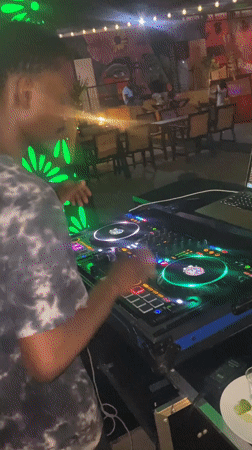Live DJ session at a neon-lit bar in Howayi, Nigeria