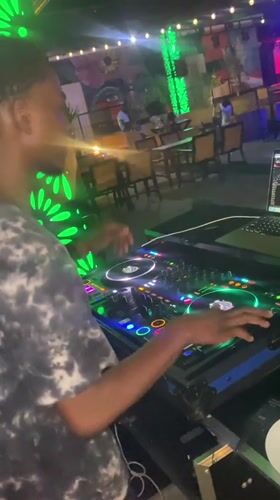 Live DJ session at a neon-lit bar in Howayi, Nigeria