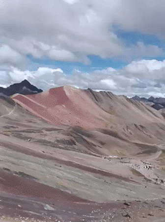 Tourists document Rainbow Mountain's colorful landscape in Peru