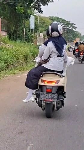Cargo bike and passenger scooter on the streets of Lhokseumawe
