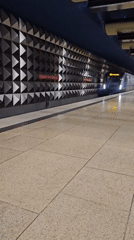 Passenger boards westbound subway train at Olympia station