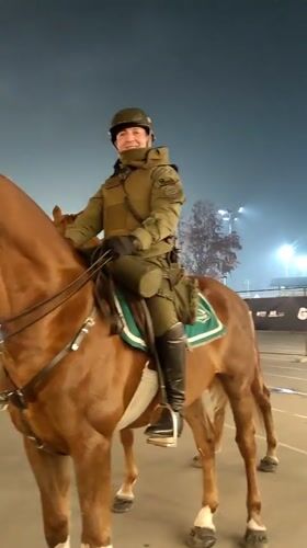 Traditional drummers perform in Santiago as mounted police patrol