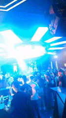 Crowded nightclub scene with performer and light effects in Nesebar