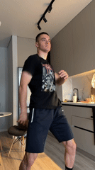 Young man dances casually in Bishkek kitchen late evening